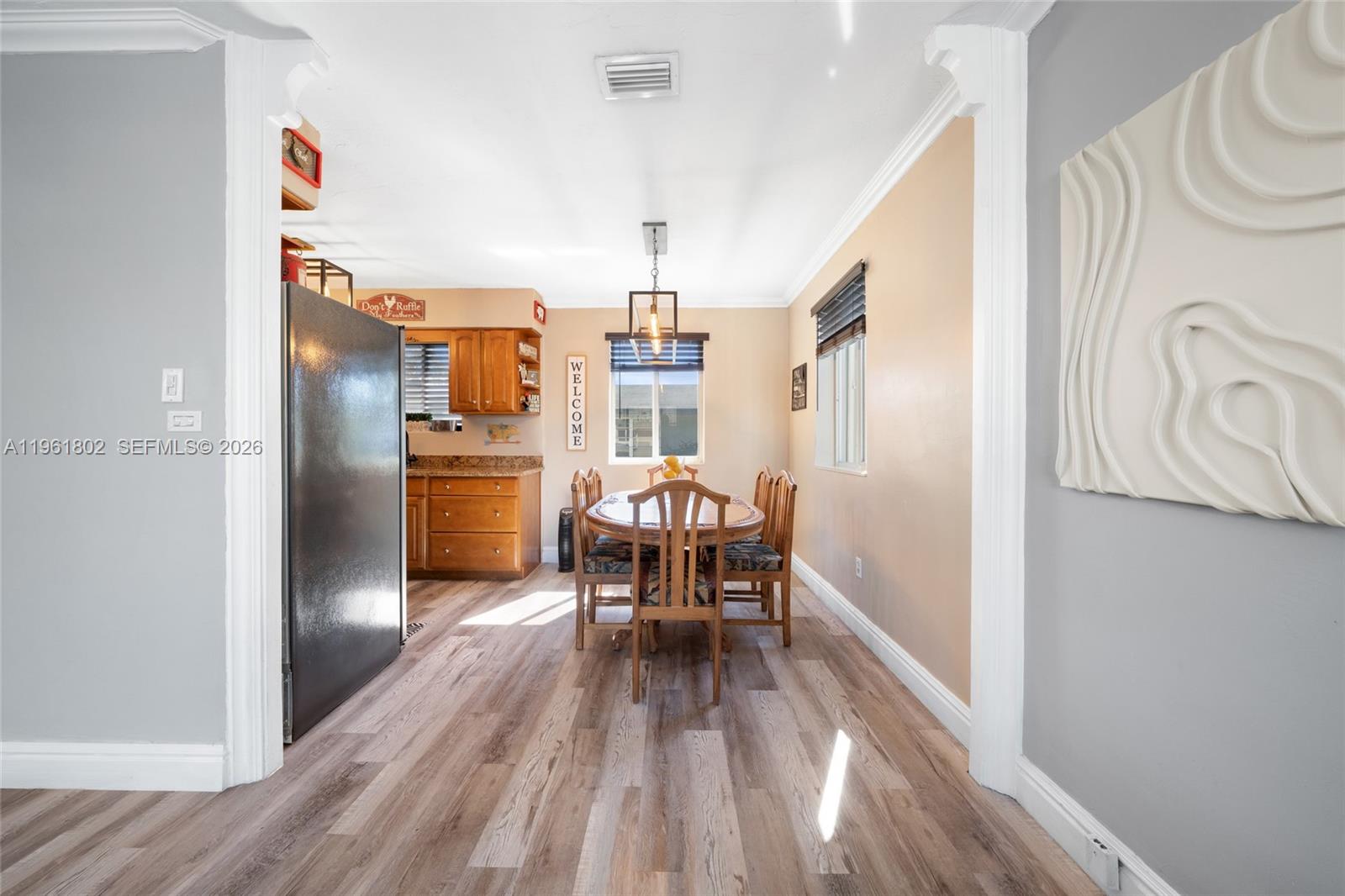 1166 West 24th Street Hialeah, FL 33010 - Photo 7 of 45 a dining room with furniture and wooden floor
