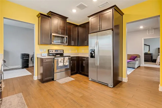 a kitchen with stainless steel appliances granite countertop a refrigerator and a sink