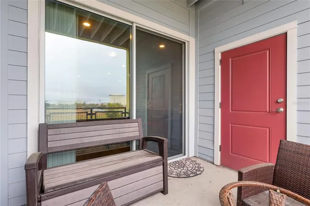 a view of a hallway with a couch and a chandelier