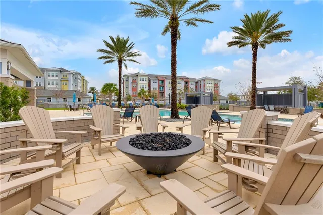a view of a swimming pool with a table and chairs