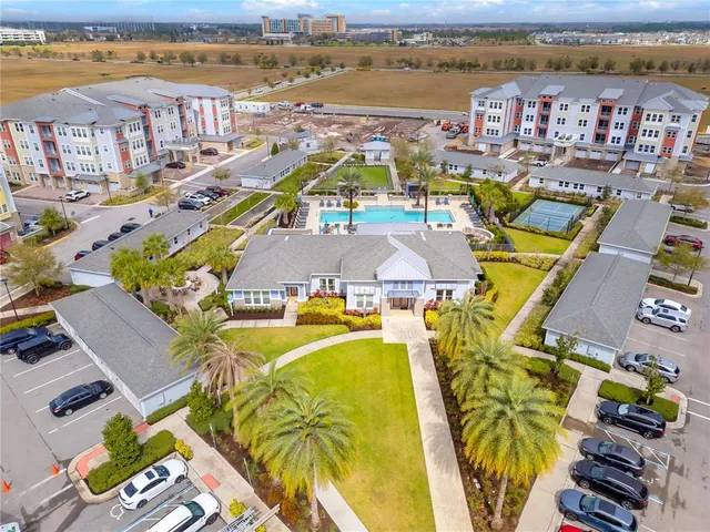 an aerial view of residential houses with outdoor space and ocean view