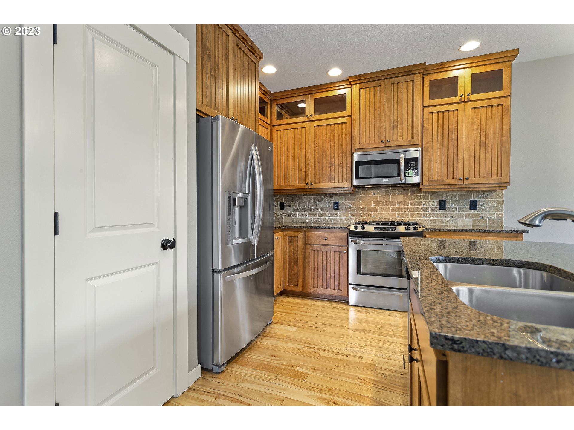 2267 Southwest 184th Terrace Beaverton, OR 97003 - Photo 5 of 39 a kitchen with stainless steel appliances granite countertop a refrigerator sink and cabinets