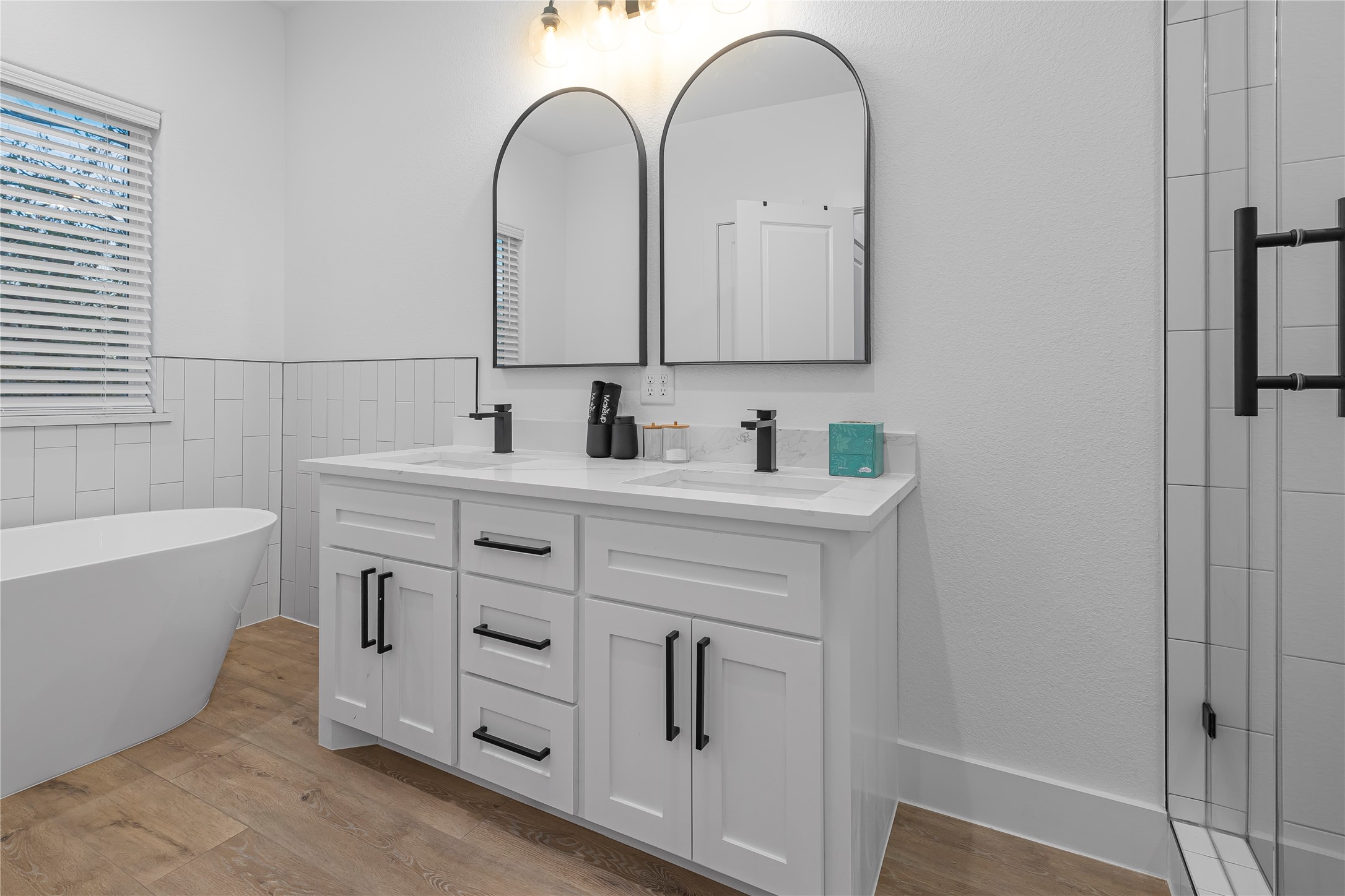 7107 Foster Street, Unit B Houston, TX 77021 - Photo 10 of 18 Elegant bathroom with a modern double vanity, stylish black fixtures, and a luxurious freestanding tub.