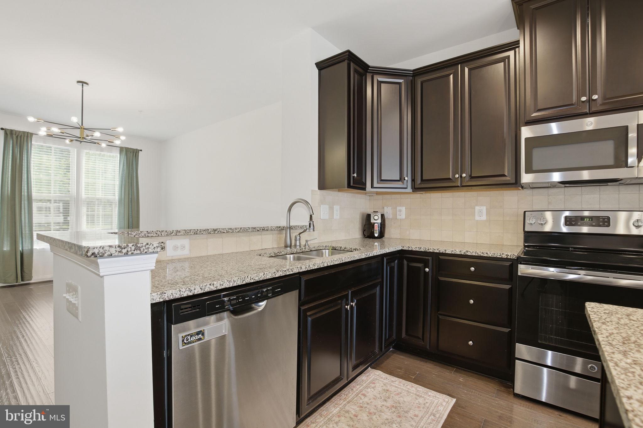 2784 Fredericksburg Road Hanover, MD 21076 - Photo 17 of 60 a kitchen with stainless steel appliances granite countertop a sink stove and cabinets
