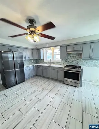 a kitchen with stainless steel appliances granite countertop a stove and a refrigerator