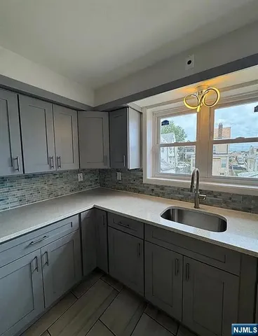 a kitchen with a sink and cabinets