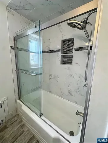 a bathroom with a bathtub and a shower