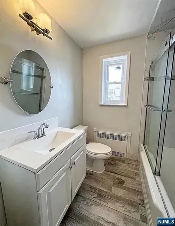 a bathroom with a toilet sink and mirror