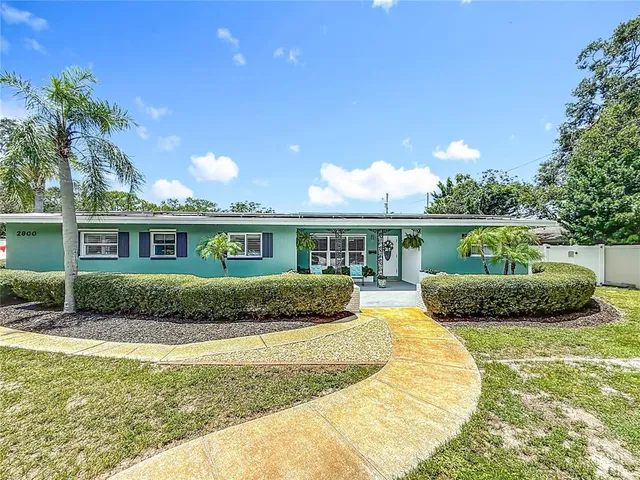 a kitchen with stainless steel appliances granite countertop a stove a sink dishwasher a refrigerator and cabinets with wooden floor