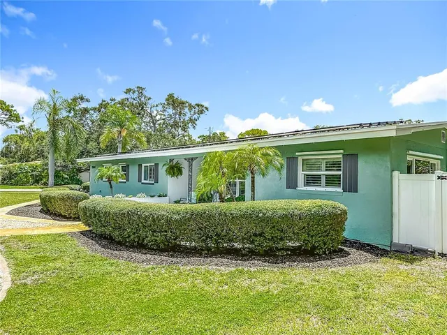 a kitchen with stainless steel appliances granite countertop a sink cabinets and wooden floor