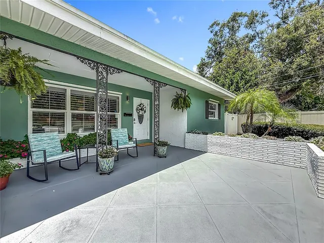 a kitchen with stainless steel appliances kitchen island granite countertop a stove a microwave oven a sink dishwasher and white cabinets with wooden floor