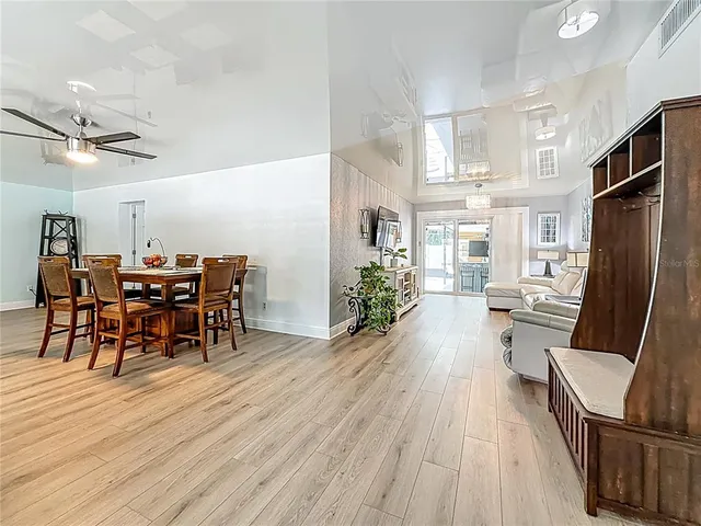 a living room with furniture and a refrigerator