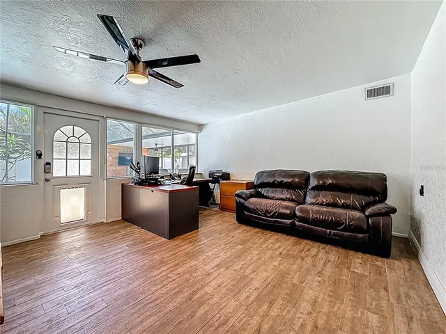 an aerial view of residential houses with outdoor space and ocean view