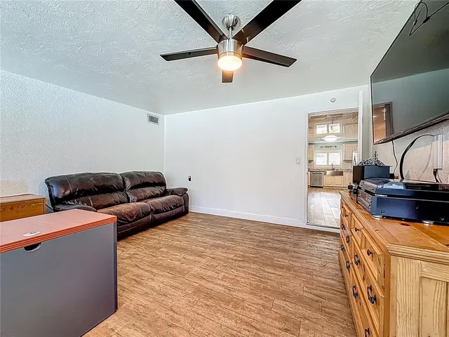 an aerial view of residential houses with yard and outdoor seating