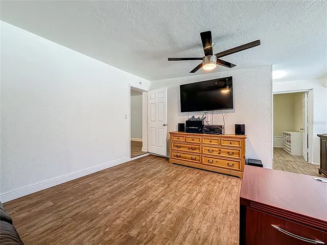 a view of a garden with a bench in front of house