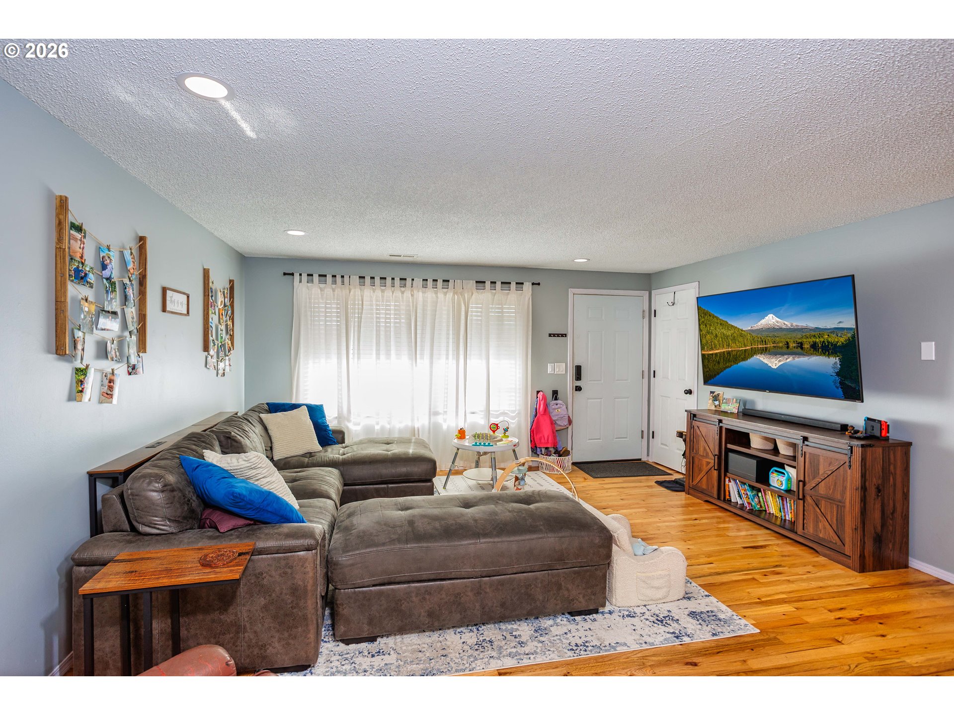 85 Northeast 23rd Street Gresham, OR 97030 - Photo 5 of 23 a living room with furniture and a flat screen tv