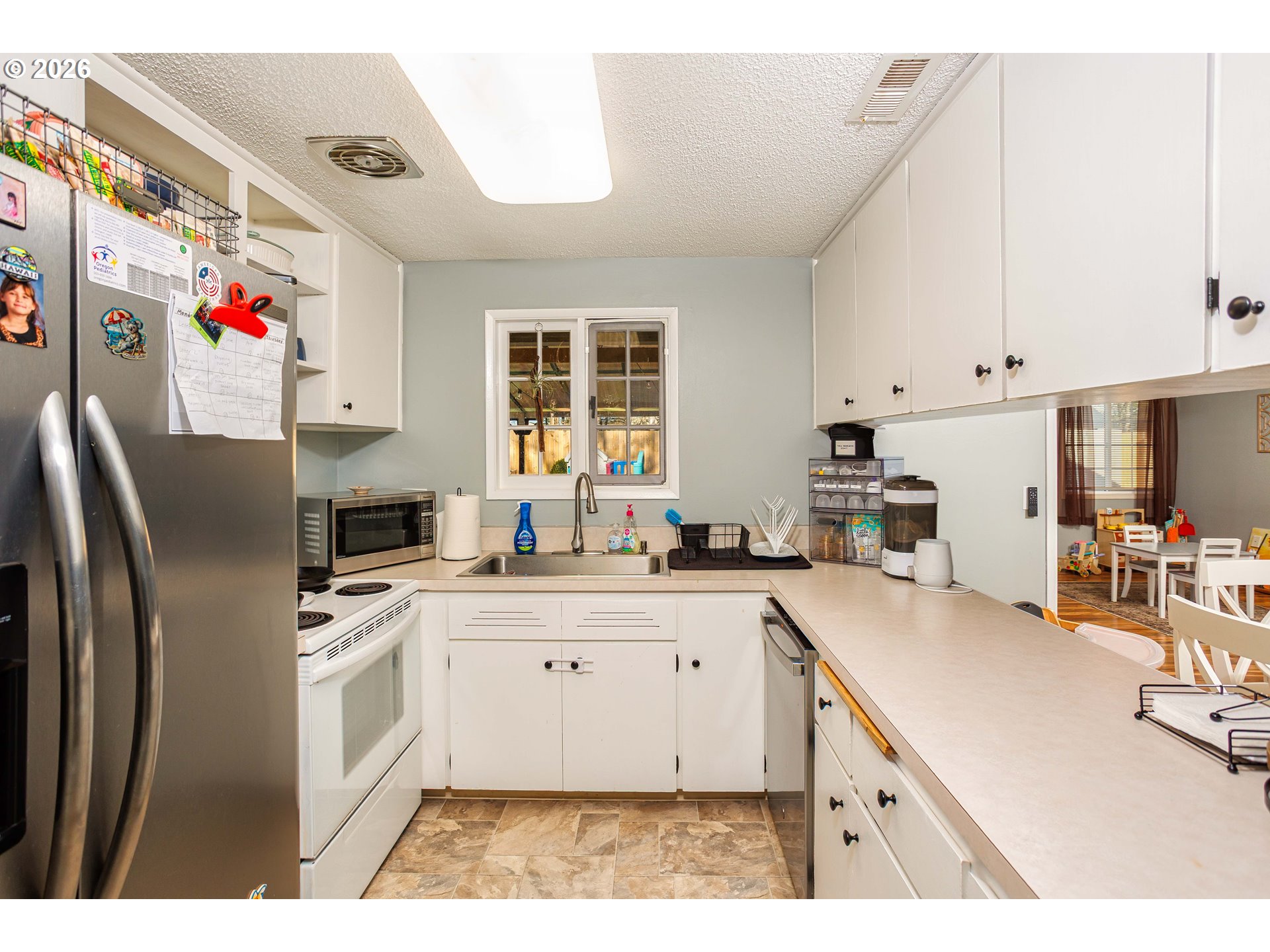 85 Northeast 23rd Street Gresham, OR 97030 - Photo 9 of 23 a kitchen with stainless steel appliances granite countertop a sink stove and refrigerator