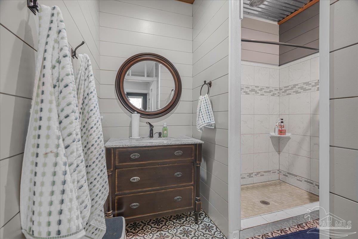 1660 Annie Penton Road Jay, FL 32565 - Photo 25 of 56 a bathroom with a sink a mirror and a shower