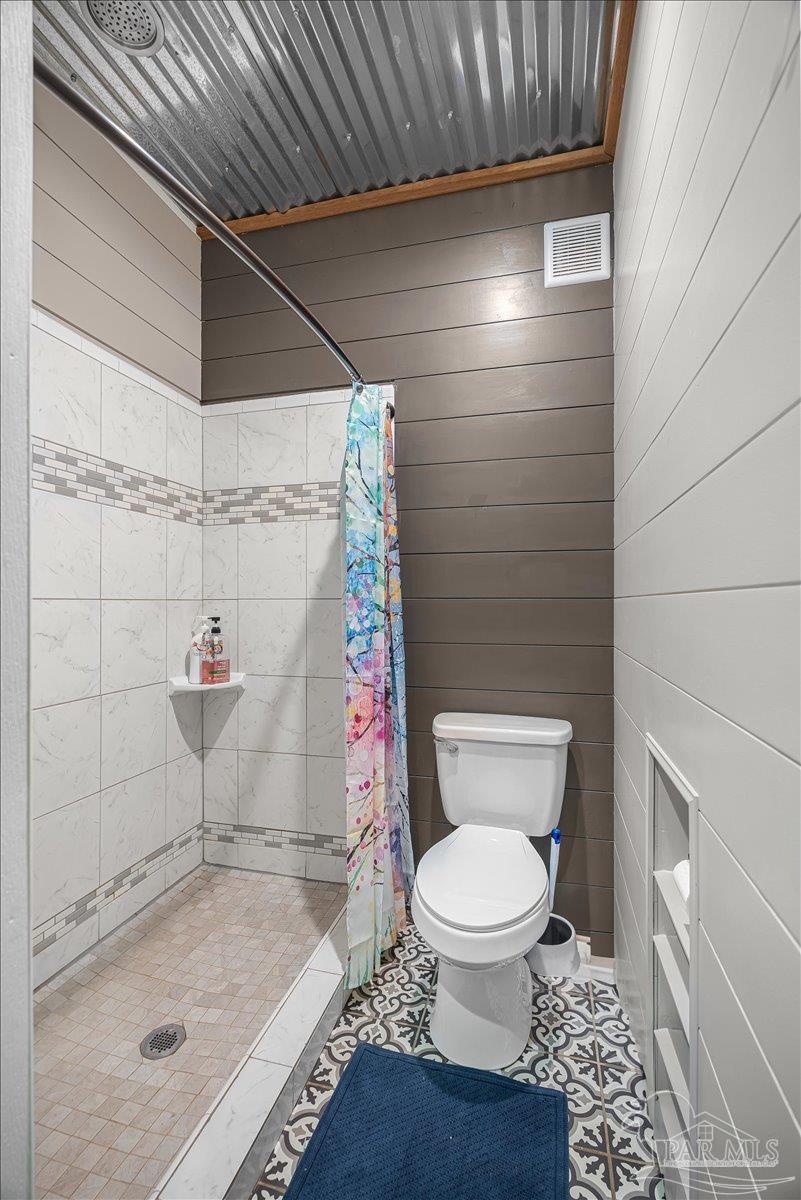 1660 Annie Penton Road Jay, FL 32565 - Photo 26 of 56 a bathroom with a toilet and a shower