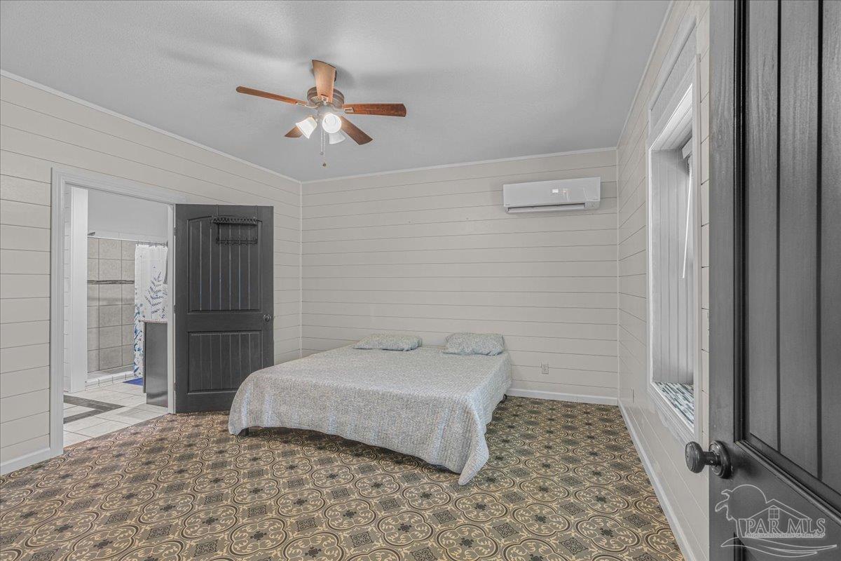 1660 Annie Penton Road Jay, FL 32565 - Photo 28 of 56 a bedroom with a bed and a rug