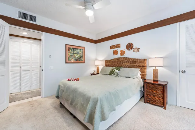 a bed room with a bed and a painting on the wall