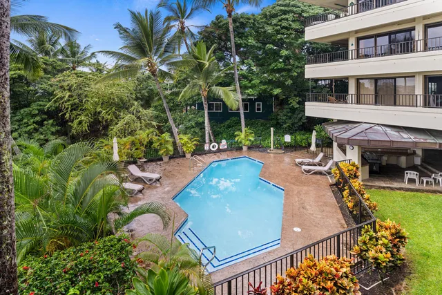 an aerial view of a house with swimming pool and patio