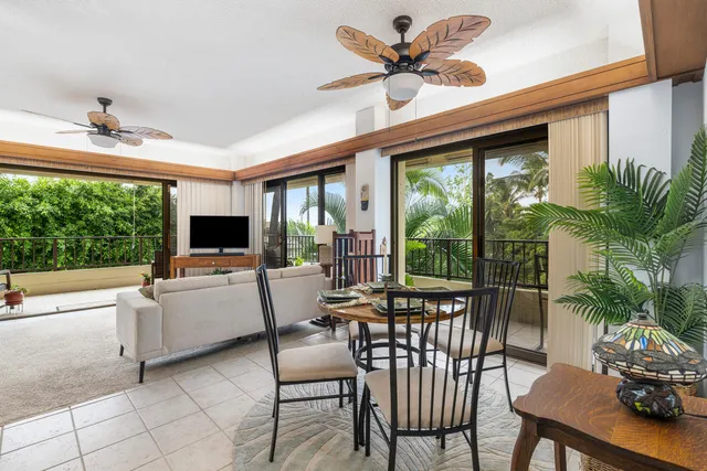 a living room with furniture tv and a large window