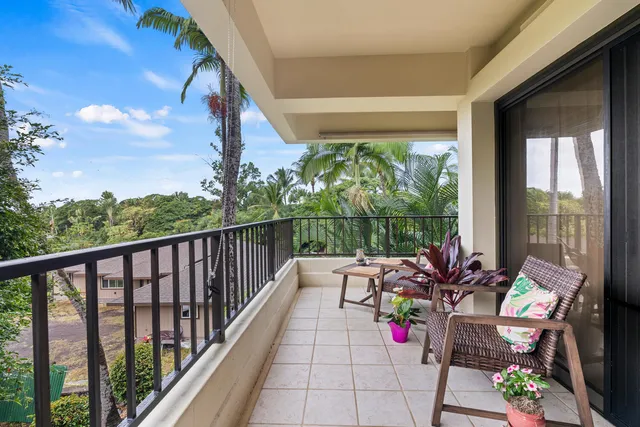 a view of balcony with furniture and garden