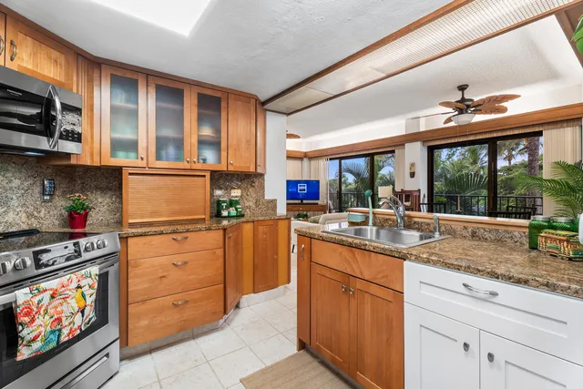 a kitchen with stainless steel appliances granite countertop a stove and a sink