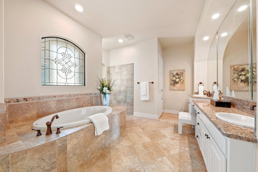 143 Champion Way Spring Branch, TX 78070 - Photo 15 of 40 a spacious bathroom with a tub sink and mirror