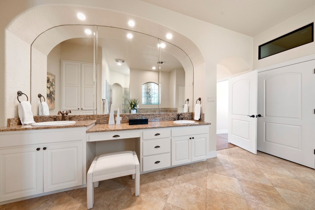 143 Champion Way Spring Branch, TX 78070 - Photo 17 of 40 a spacious bathroom with a granite countertop sink a mirror and a