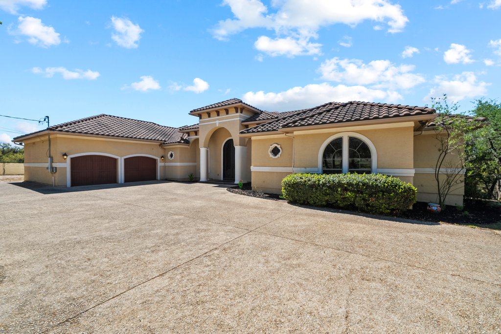 143 Champion Way Spring Branch, TX 78070 - Photo 2 of 40 a front view of a house with a yard