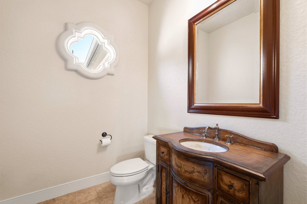 143 Champion Way Spring Branch, TX 78070 - Photo 23 of 40 a bathroom with a sink a toilet and mirror