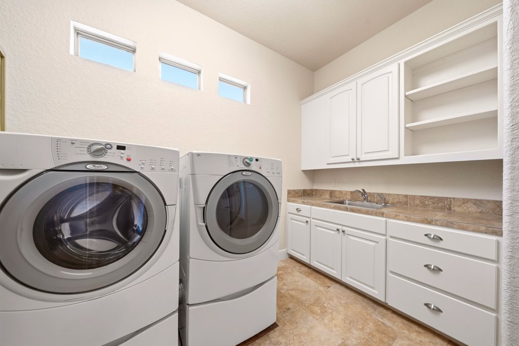 143 Champion Way Spring Branch, TX 78070 - Photo 24 of 40 a utility room with sink dryer and washer