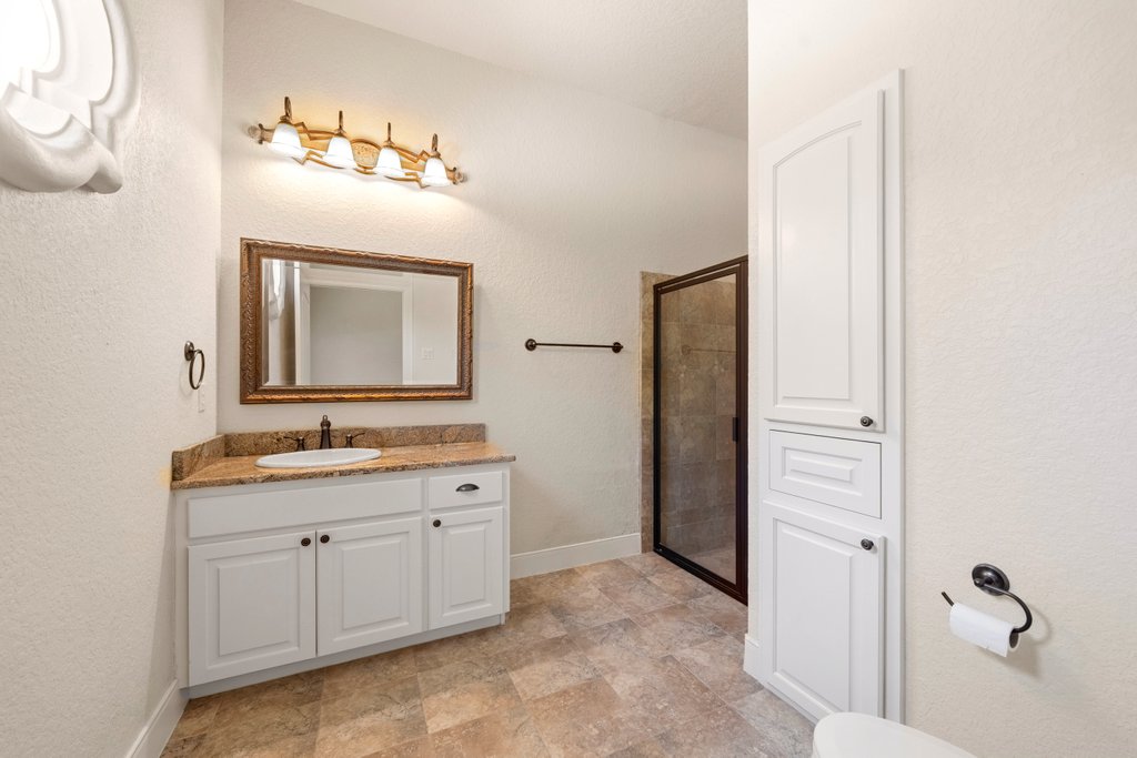 143 Champion Way Spring Branch, TX 78070 - Photo 27 of 40 a bathroom with a toilet sink and mirror
