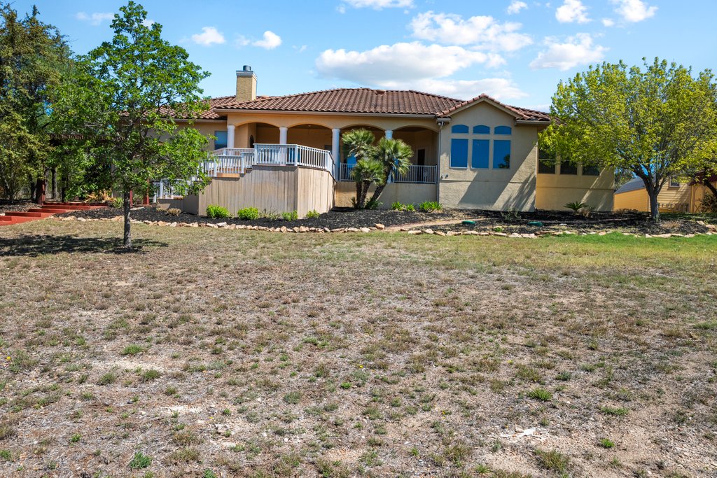 143 Champion Way Spring Branch, TX 78070 - Photo 35 of 40 a front view of a house with garden