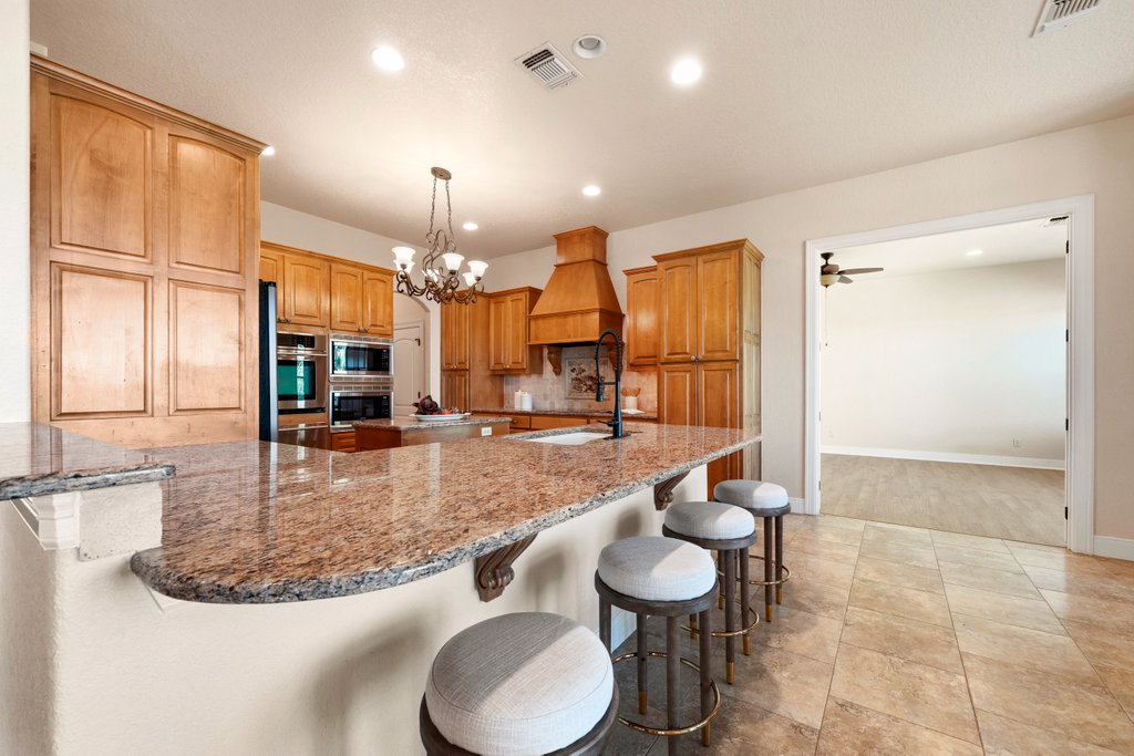 143 Champion Way Spring Branch, TX 78070 - Photo 6 of 40 a kitchen with stainless steel appliances granite countertop a sink and a refrigerator