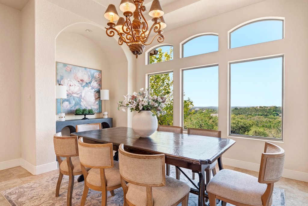 143 Champion Way Spring Branch, TX 78070 - Photo 10 of 40 a dining room with furniture a large window and a chandelier