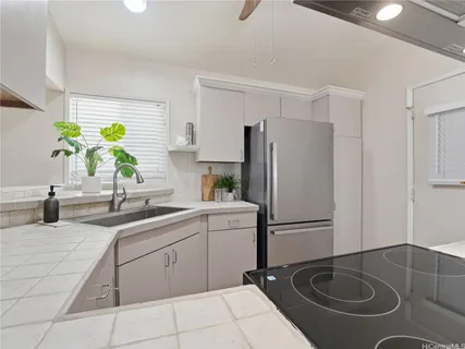 a kitchen with a sink appliances and cabinets