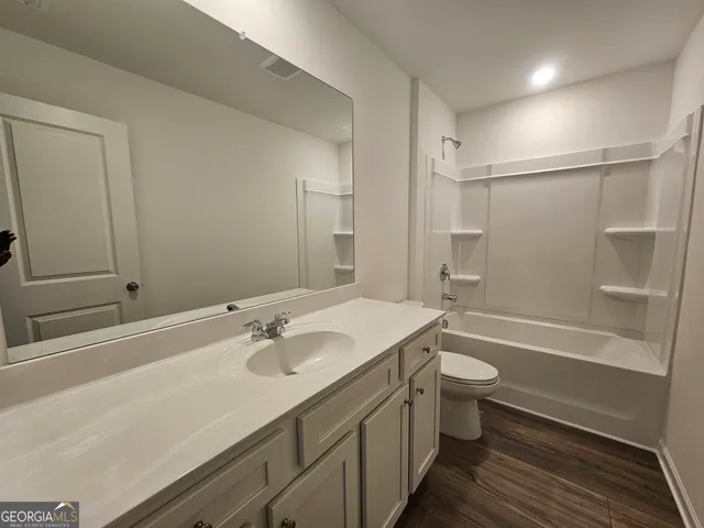 a bathroom with a sink a toilet a bathtub and shower