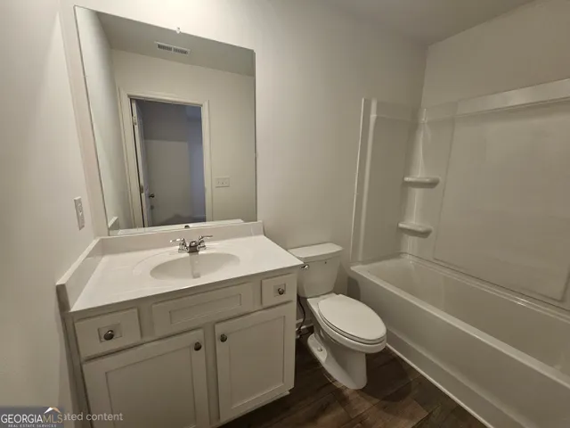 a bathroom with a toilet a sink and a bathtub