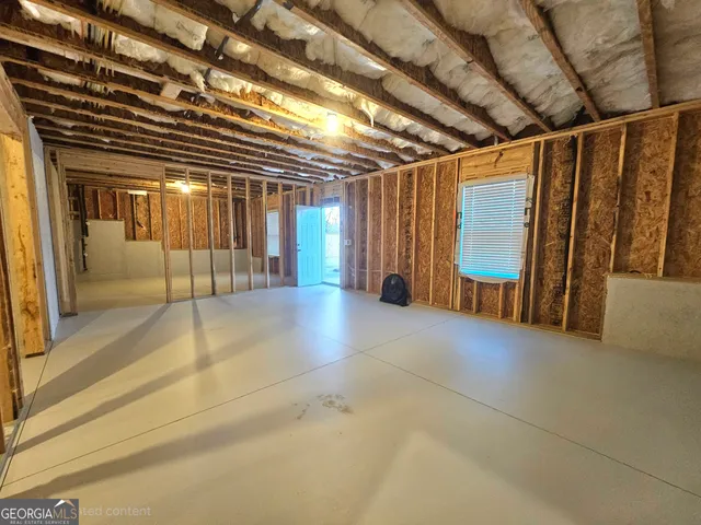 a view of water heater room with stairs