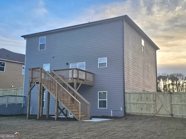 a view of house with deck and outdoor space