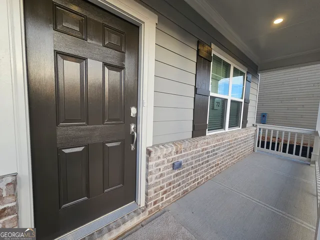 front view of a house with a door and wooden door