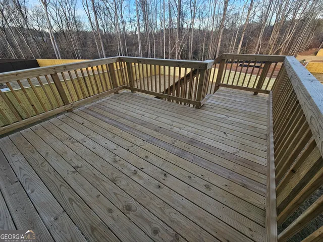 a view of deck with wooden floor and fence