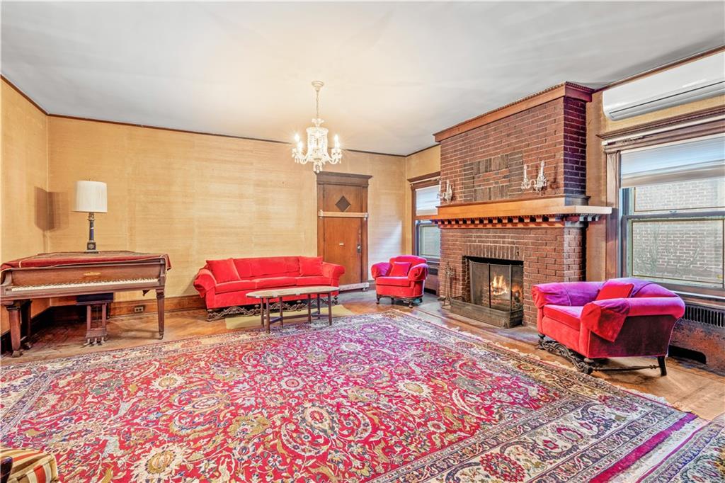 976 Ocean Avenue Brooklyn, NY 11226 - Photo 2 of 24 a bedroom with furniture and a fireplace