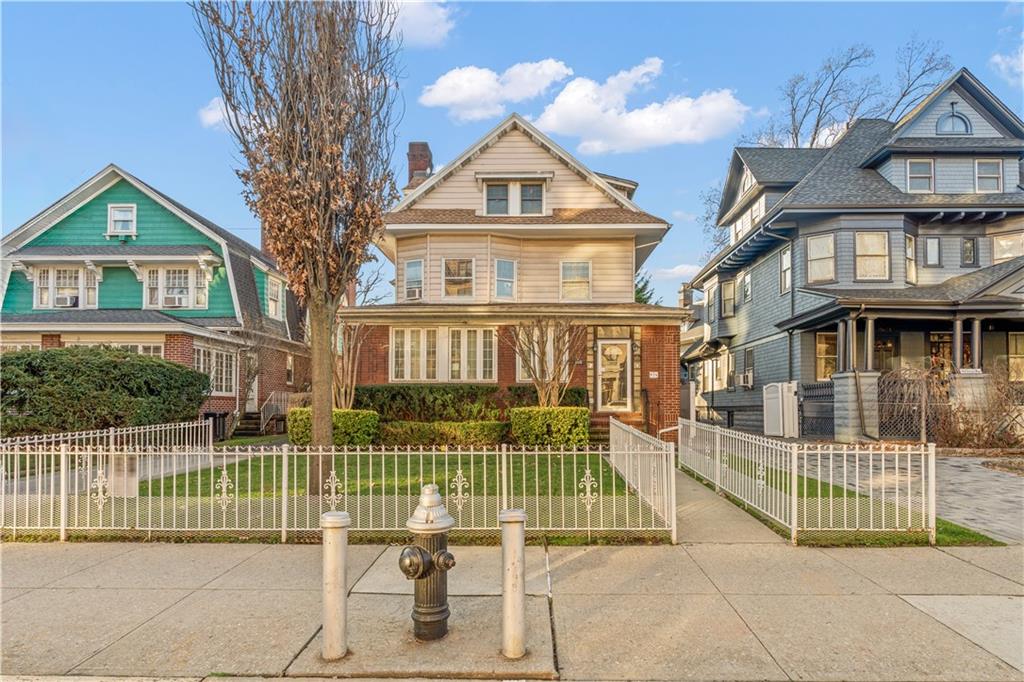 976 Ocean Avenue Brooklyn, NY 11226 - Photo 24 of 24 a view of a brick house with a small yard and plants