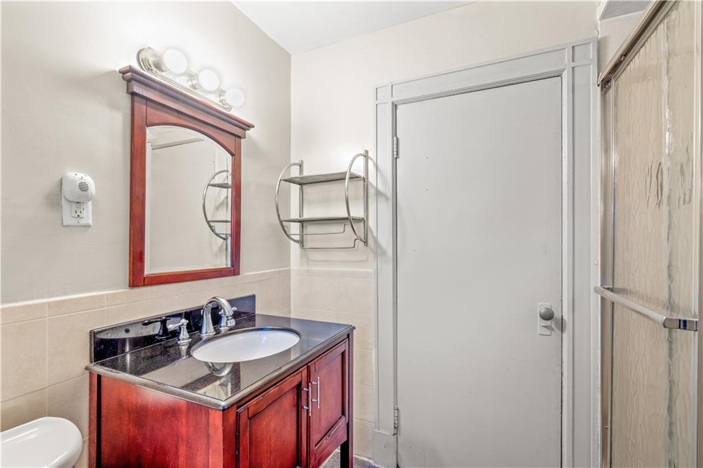 976 Ocean Avenue Brooklyn, NY 11226 - Photo 7 of 24 a bathroom with a sink a toilet and a mirror