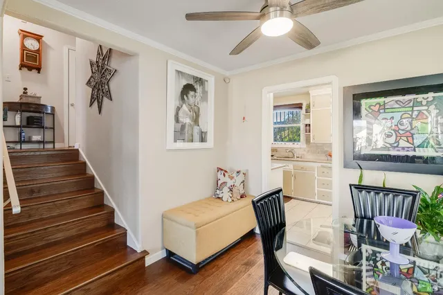 a view of a livingroom with furniture a chandelier and wooden floor