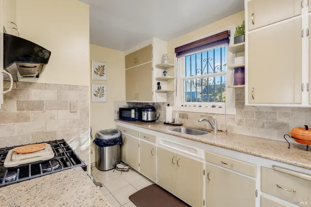 a kitchen with a sink a stove and a microwave
